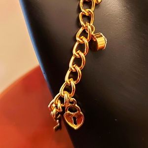 Fallon signed gold tone charmed bracelet